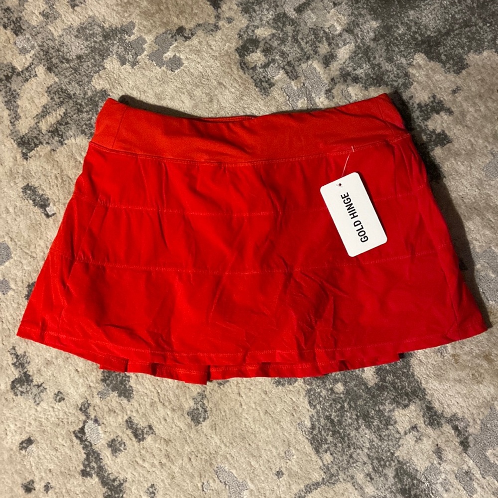 Gold hinge red tennis skirt
